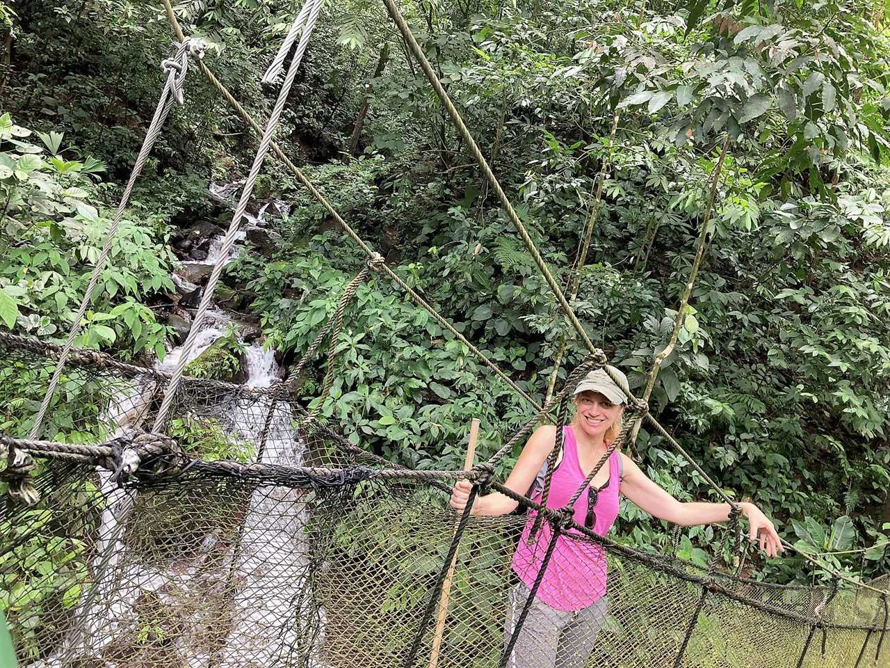 woman in a hanging bridge in rainmaker park costa rica