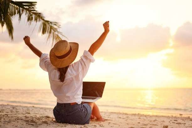 woman with a laptop on the beach