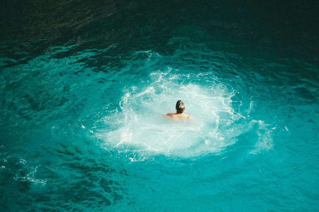 person swimming on a beach in Negril, Jamaica