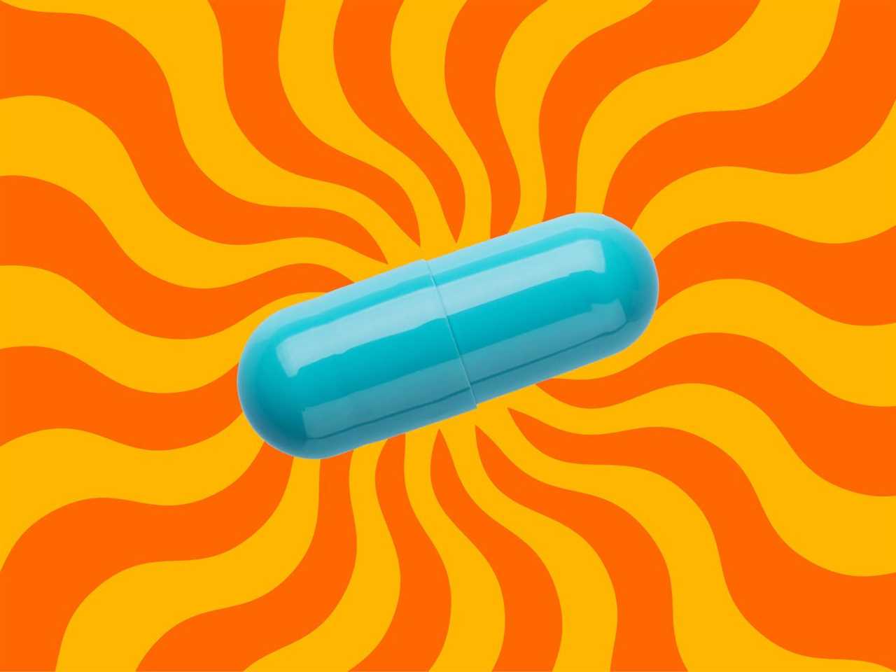 A turquoise capsule on a background of orange and yellow wavy rays of sun.