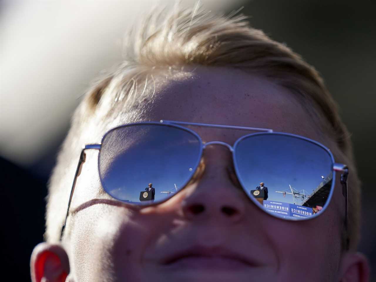 President Joe Biden is reflected in a child’s sunglasses as he speaks at Tioga Marine Terminal, October 13, 2023, in Philadelphia.