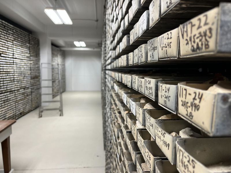 A room with shelves of trays holding mud cores.