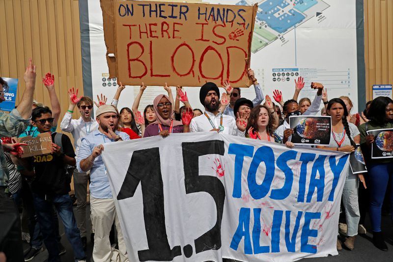 Activists chant slogans as they hold up a banner reading “1.5 to stay alive”, referring to demands to limit global temperature rise to 1.5 degrees Celsius compared to pre-industrial levels, during a demonstration at the COP27 climate conference in Egypt’s Red Sea resort city of Sharm el-Sheikh on November 16, 2022