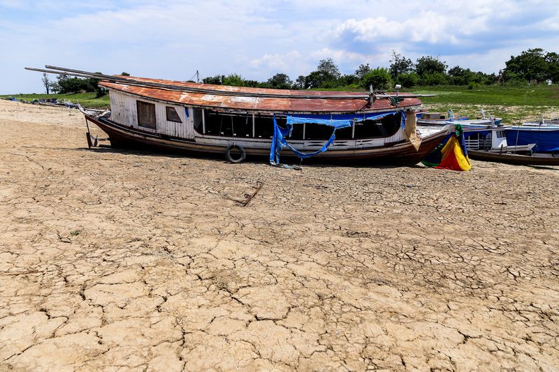 Boats stranded due to drought lie on the edge of the dried-up Laguna da Francesa, Brazil.