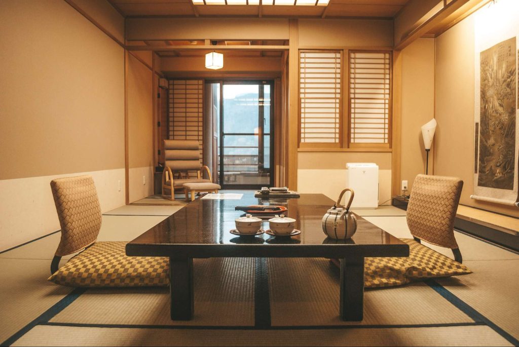 two-floor chairs on top of the tatami floor near a wooden table