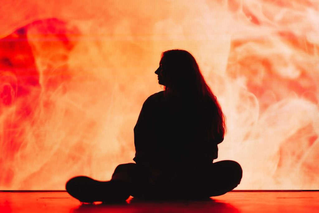 silhouette of a woman sitting on the floor