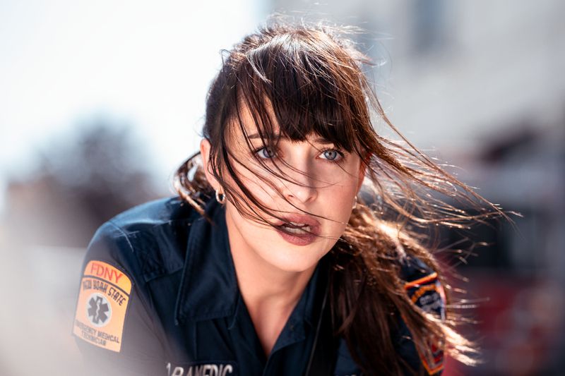 Johnson as Webb in an EMT uniform with windblown hair. 