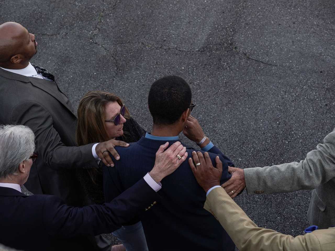 Mourners are seen from overhead.