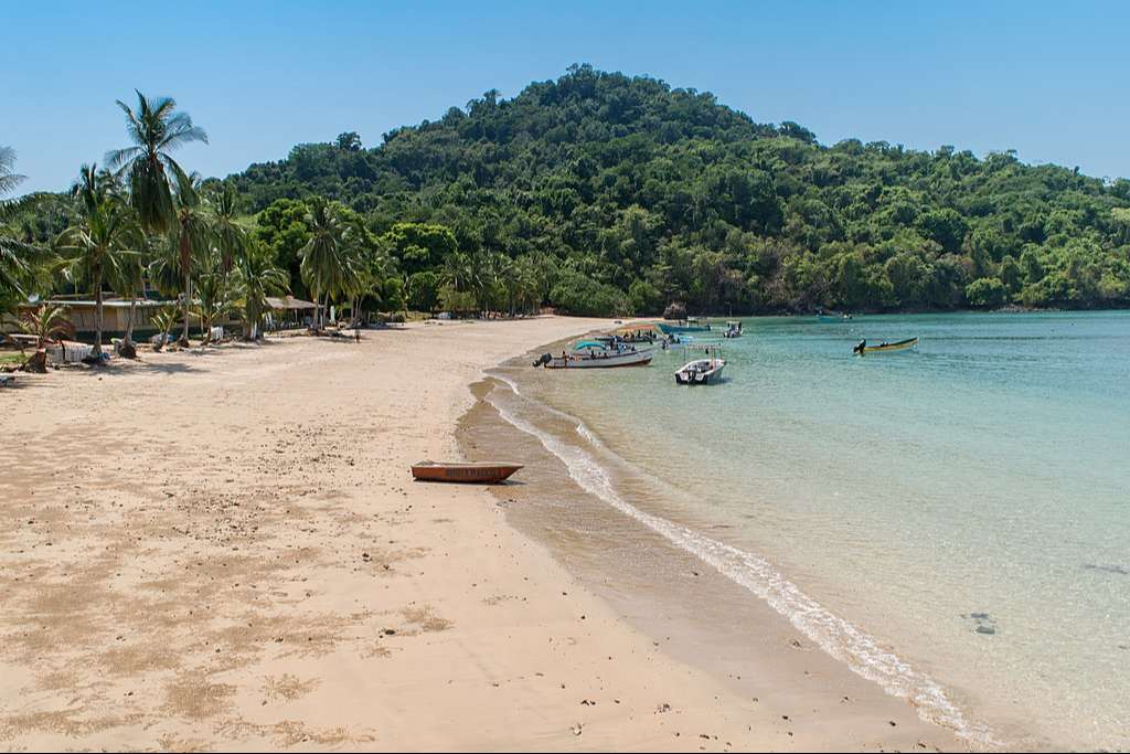 beach and boats in coiba national park panama