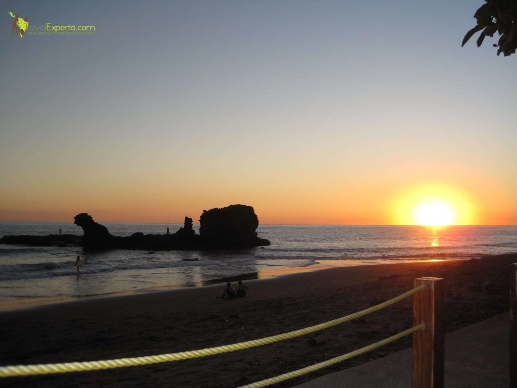 view of the beach during sunset in playa tunco volcanic beach el salvador