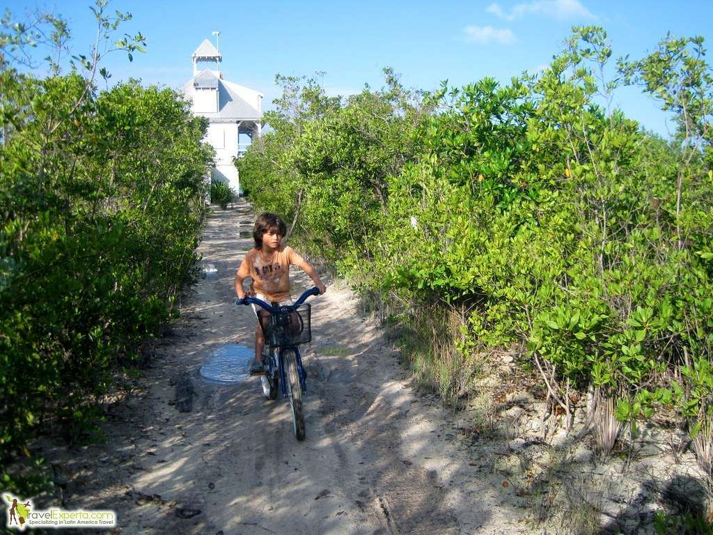 kid biking on a narrow path in belize