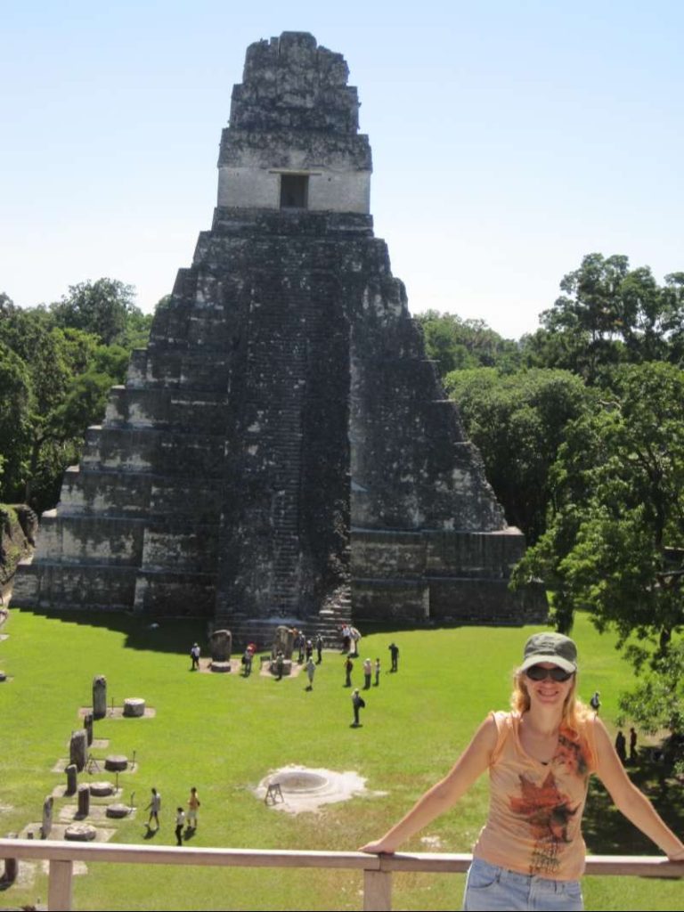 woman in front of tikal temple guatemala