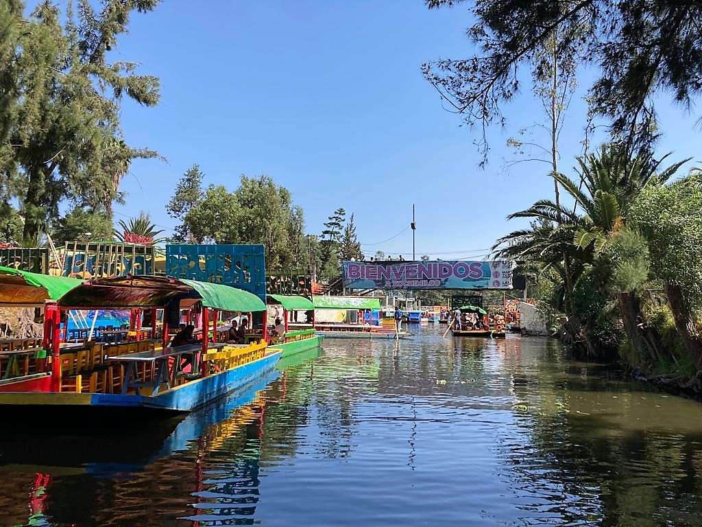 boats in a river or canal in xochimilco, mexico city