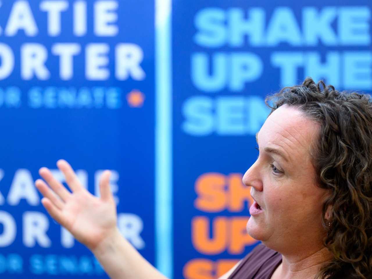 Senate candidate Katie Porter speaks in front of signs that read “Shape up the Senate” and “Katie Porter for Senate.”