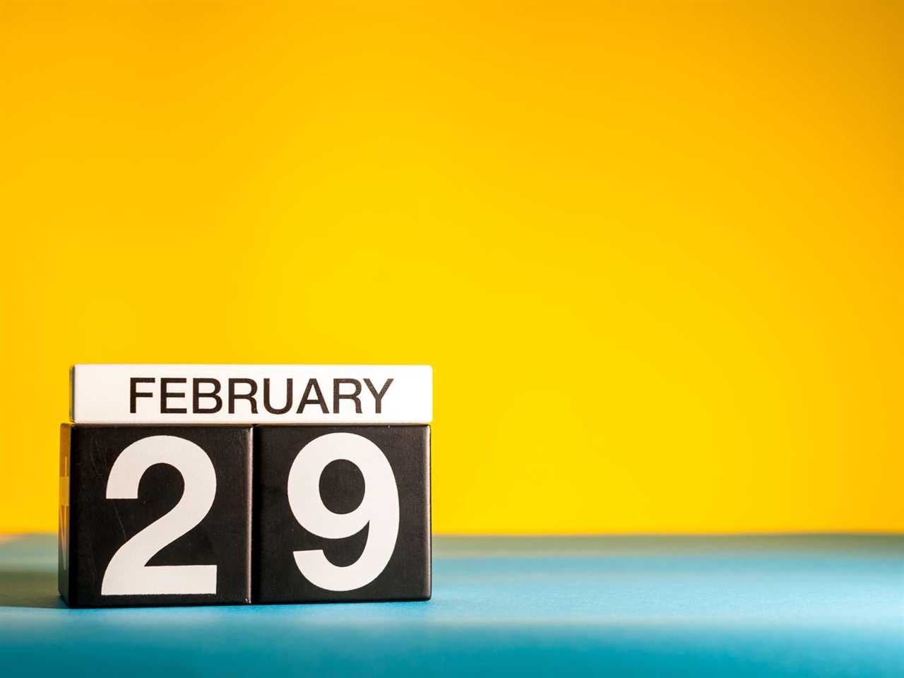 A calendar block date says February 29 in front of a yellow background.