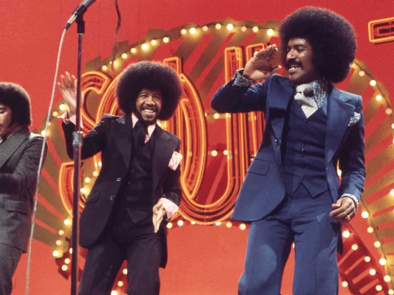 The Chi-Lites performing on a bright red Soul Train stage.