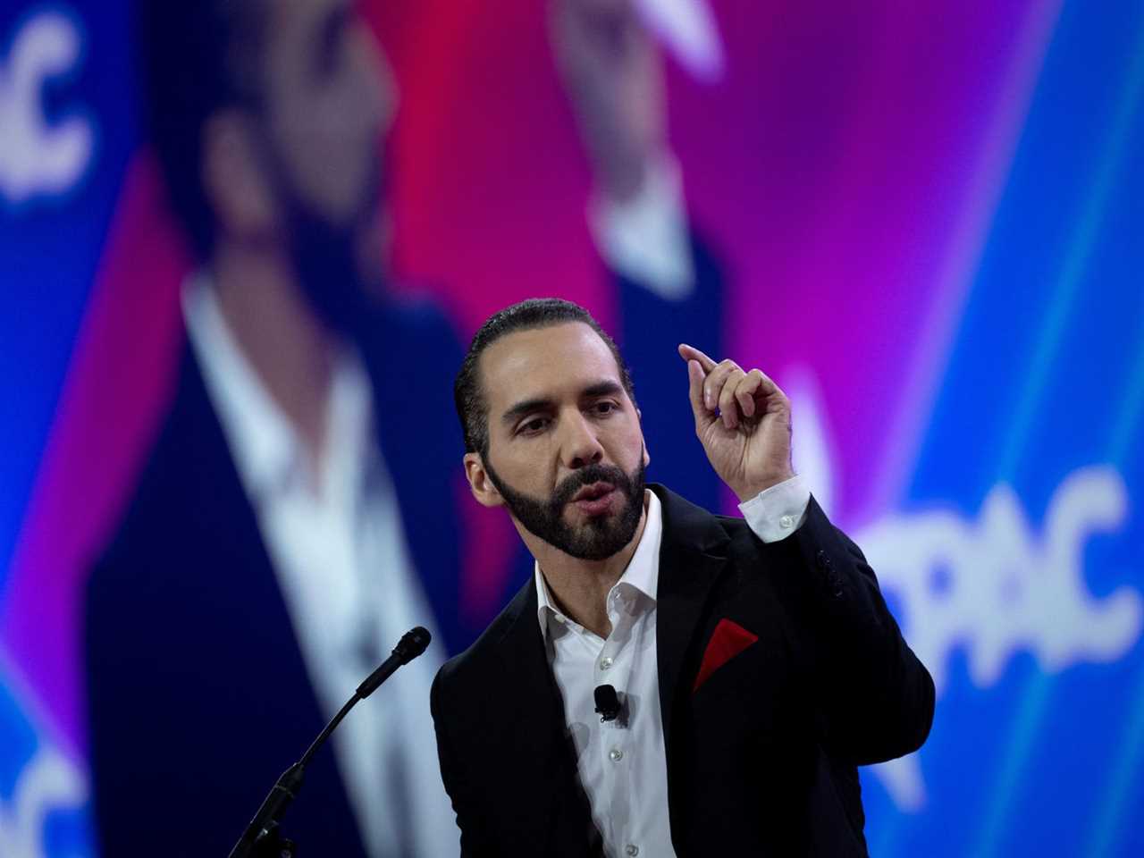 Bukele gestures with CPAC branding behind him.