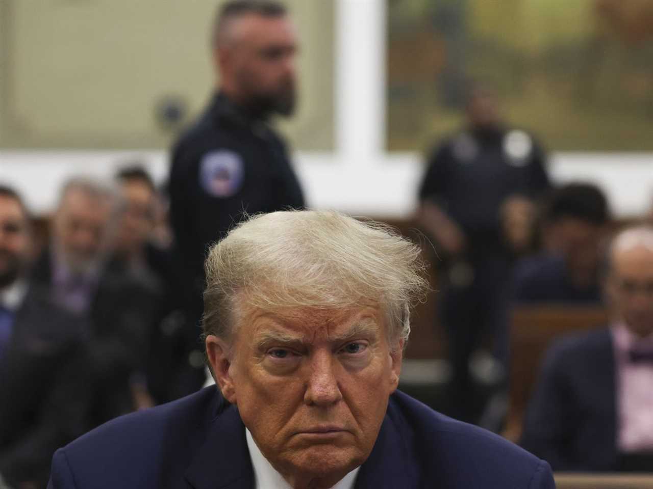 Donald Trump’s face is in focus in a courtroom during his fraud trial.